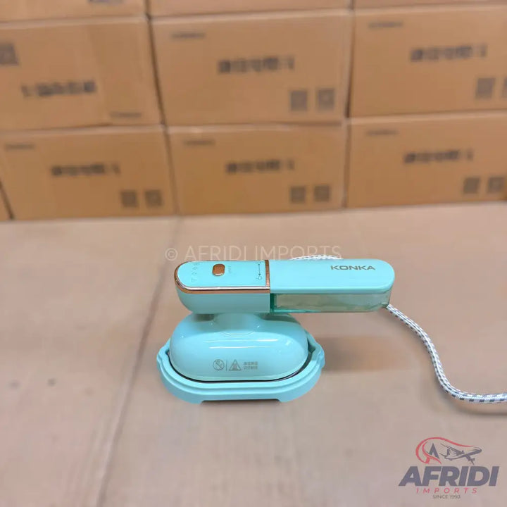 A light blue and rose gold portable steam iron with a braided power cord.