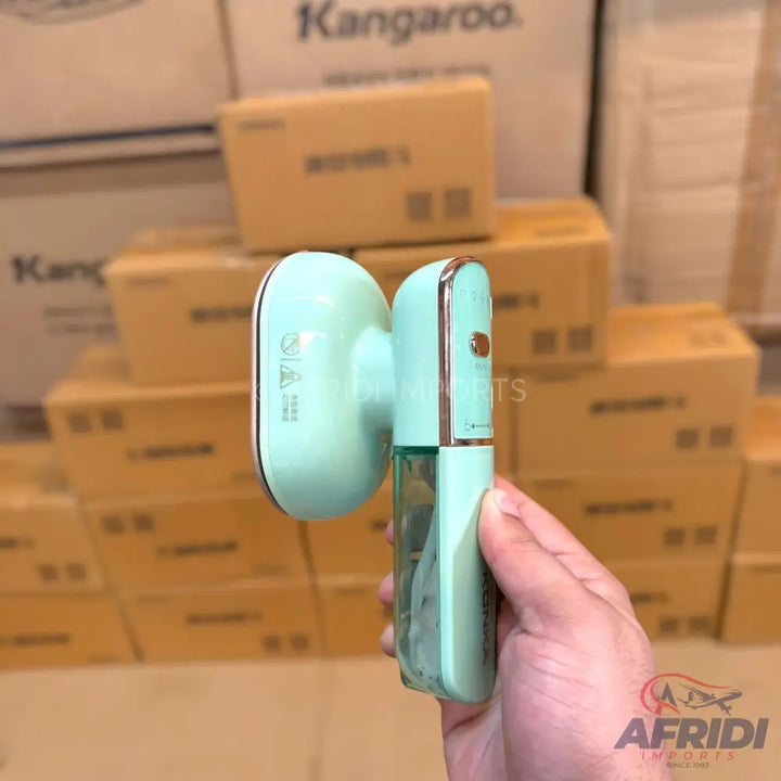 Mint green handheld garment steamer with a clear water tank.