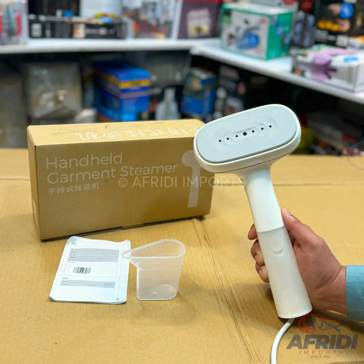 White handheld garment steamer with a light gray head.