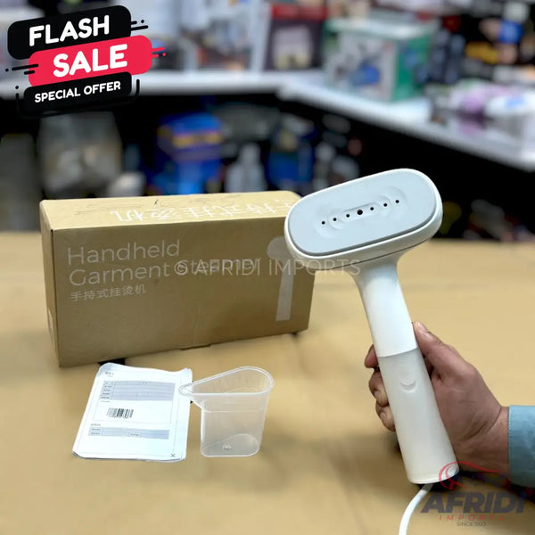 White handheld garment steamer with a water reservoir and steam vents.