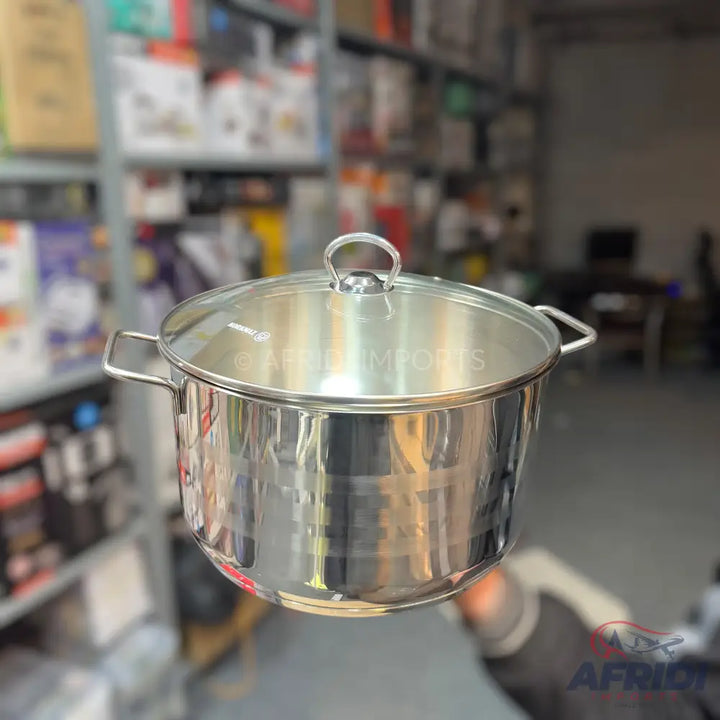 Stainless steel cooking pot with a glass lid.