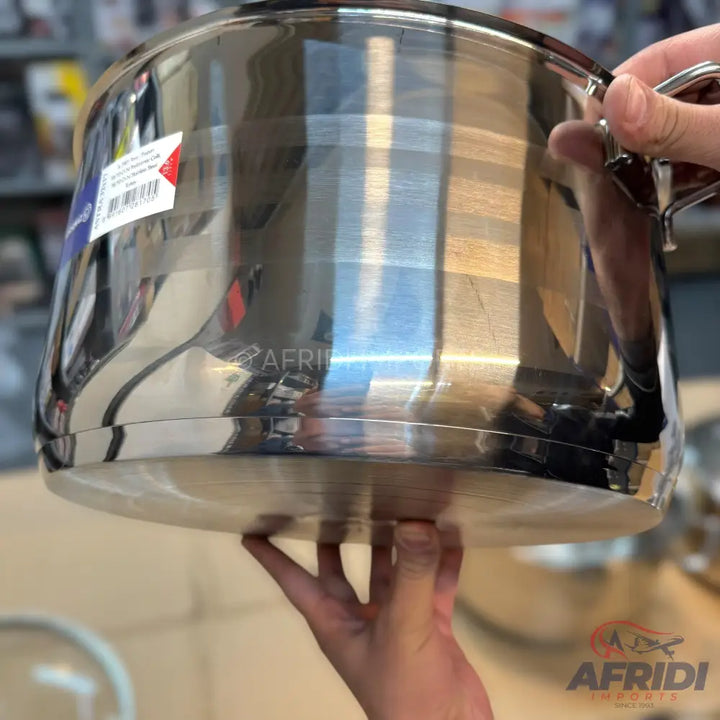 A shiny stainless steel cooking pot with handles.