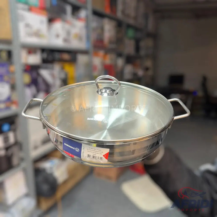 Stainless steel shallow pot with a glass lid.