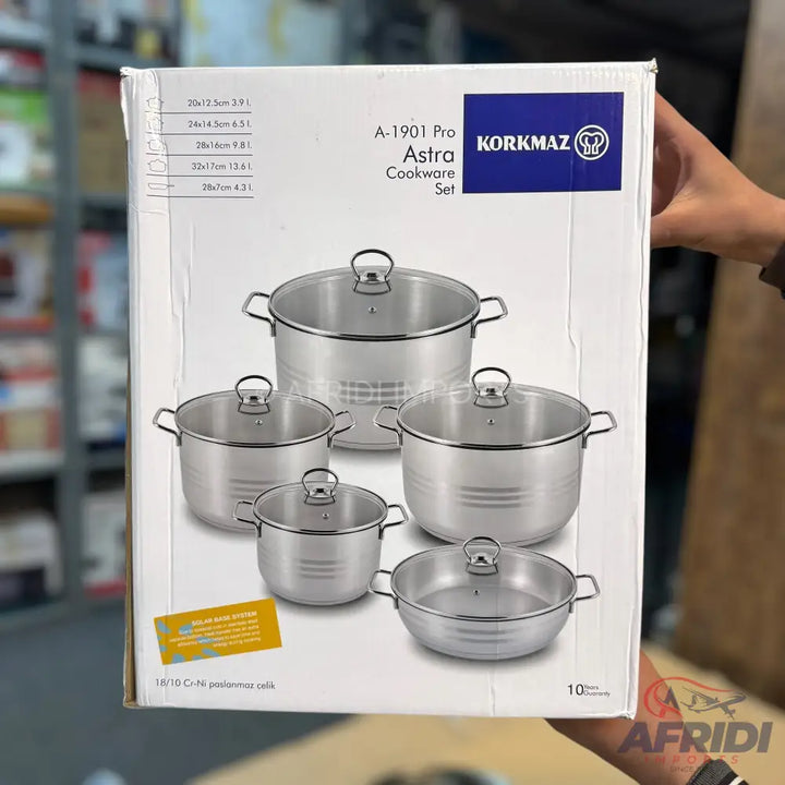 A stainless steel cookware set with glass lids.
