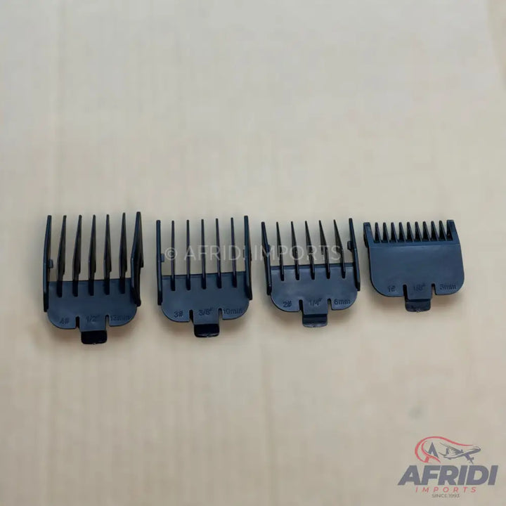 Four black plastic hair clipper guards of varying sizes.