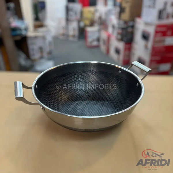Stainless steel wok with a honeycomb non-stick interior and two side handles.
