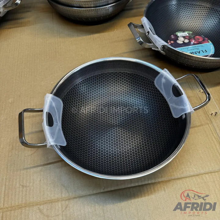 A black non-stick cooking pot with a honeycomb pattern and two metal handles.