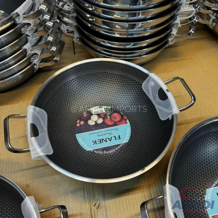 Black non-stick pan with a hexagonal pattern and two handles.