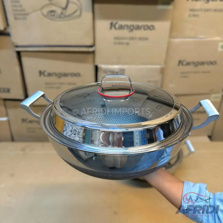 Stainless steel cooking pot with a glass lid.