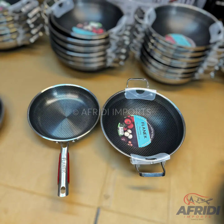 A set of two non-stick frying pans, one with a long handle and the other with two short handles.