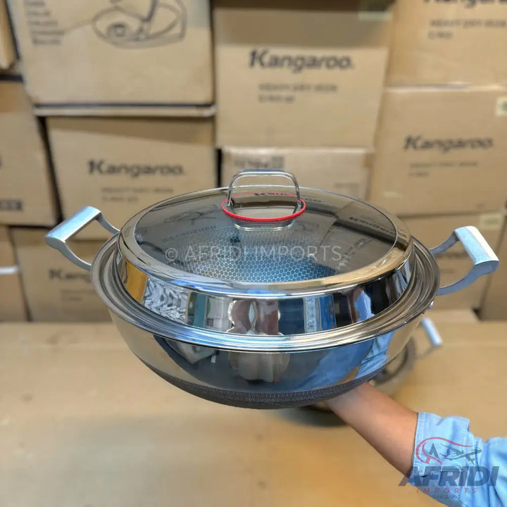 Stainless steel pot with a glass lid and two side handles.