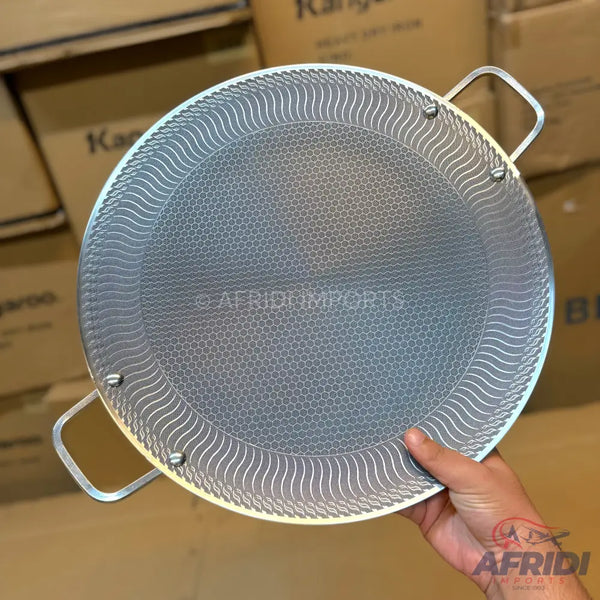 Round griddle pan with textured non-stick surface and two handles.