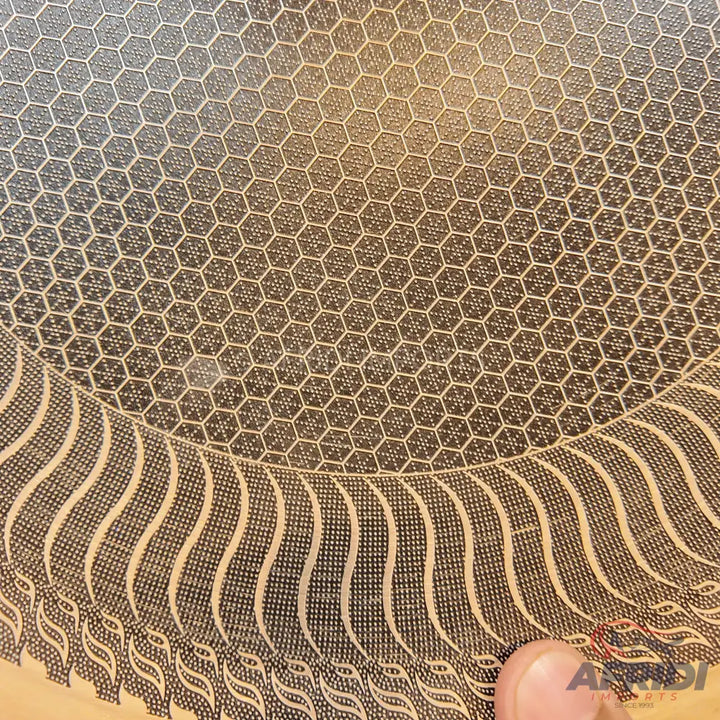 Hexagonal patterned non-stick cooking surface.