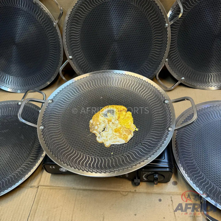 A set of round, flat griddles with a textured non-stick surface and two handles, ideal for cooking flatbreads or eggs.