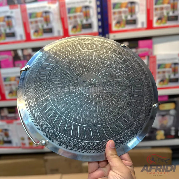 Stainless steel cooking pan with an etched, decorative pattern.