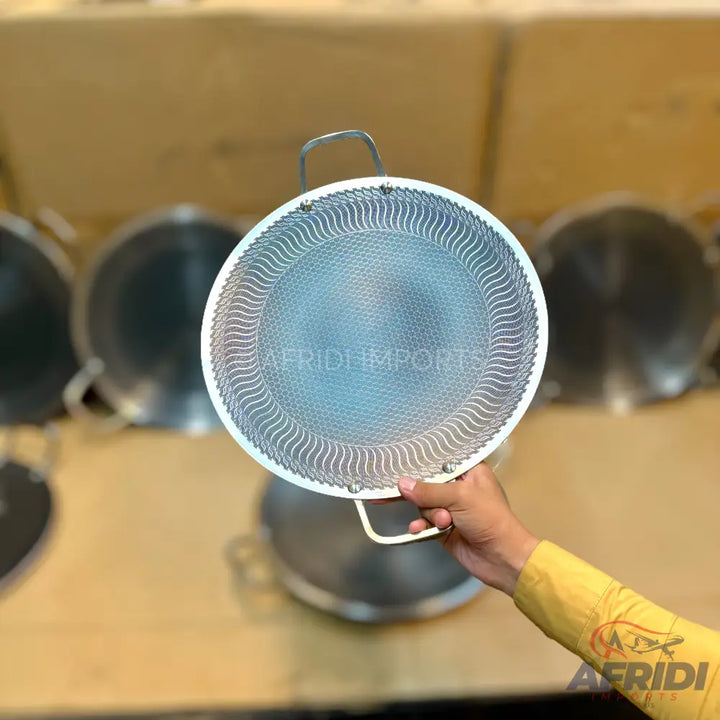 Round metal splatter screen with a white rim and two handles.