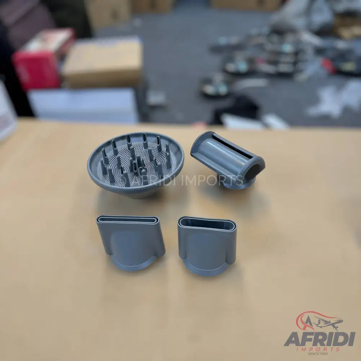 A set of four gray hair dryer attachments, including a diffuser and three concentrator nozzles.