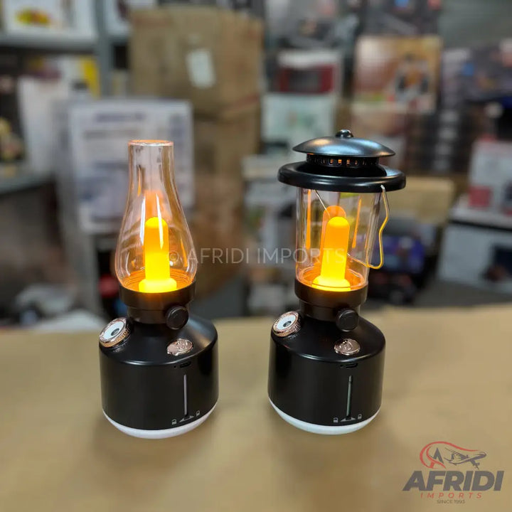 Two black and white vintage-style lanterns with glowing orange light bulbs.