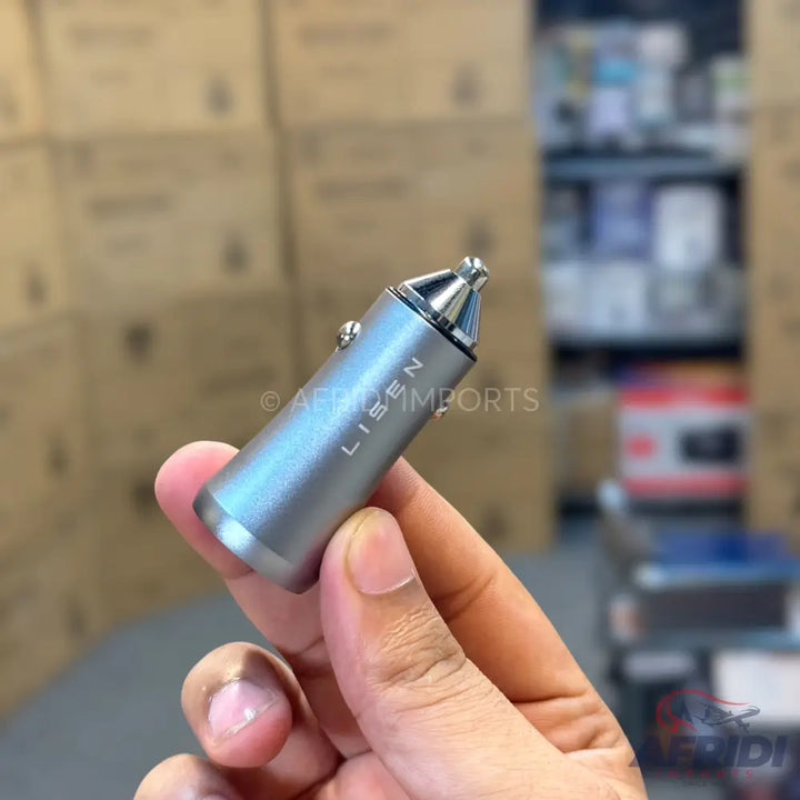 Silver car charger with a pointed tip.