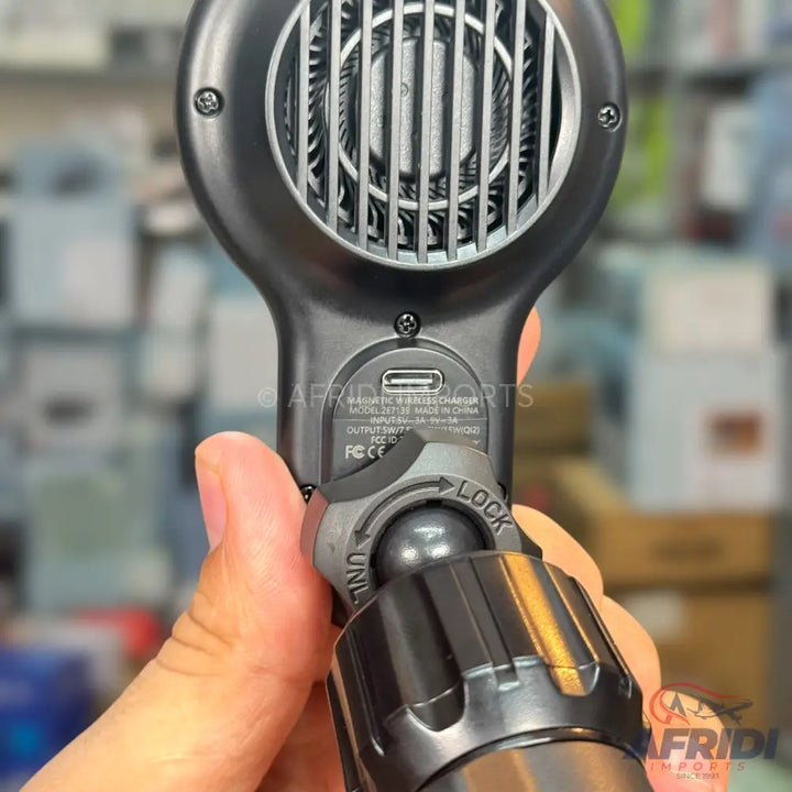 Black handheld magnetic wireless charger with a cooling fan and an adjustable mount.