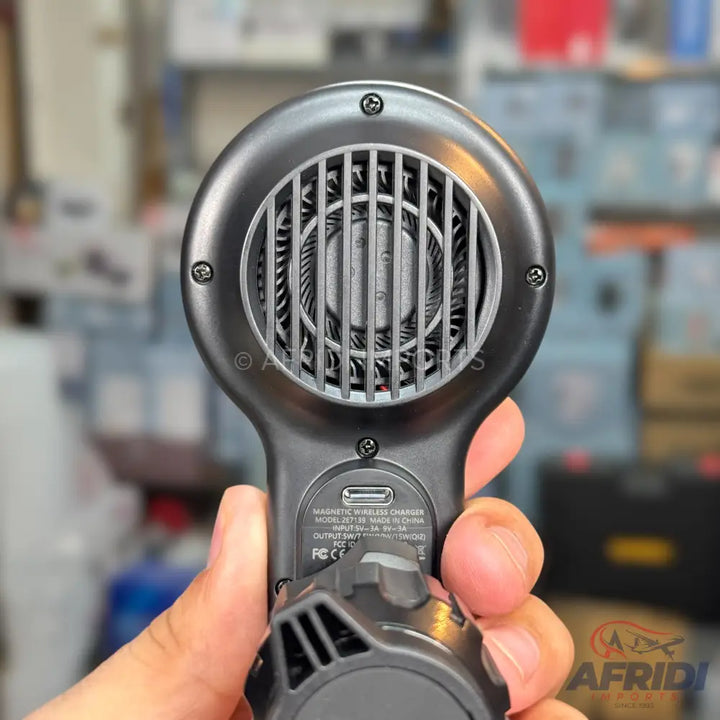 Handheld black phone cooler with a visible fan and a USB-C charging port.