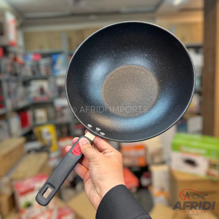 Black non-stick cooking wok with a removable handle.