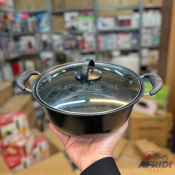 Black cooking pot with a glass lid and two handles.