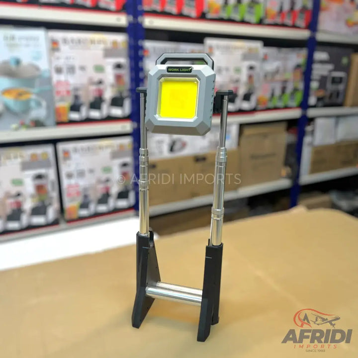 Portable work light with an extendable tripod stand.