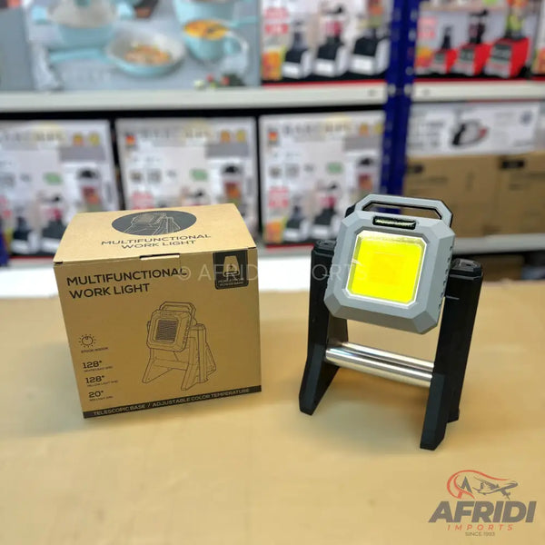 Gray and black multifunctional LED work light with a sturdy stand.