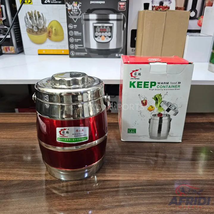 Red and silver insulated food container with a handle.