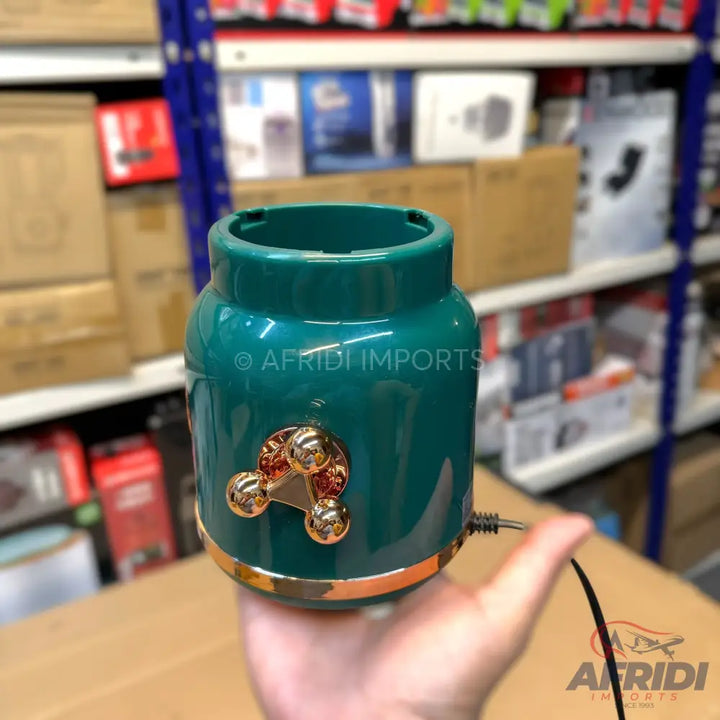 Teal-colored portable massager with three golden massage balls and a gold trim.