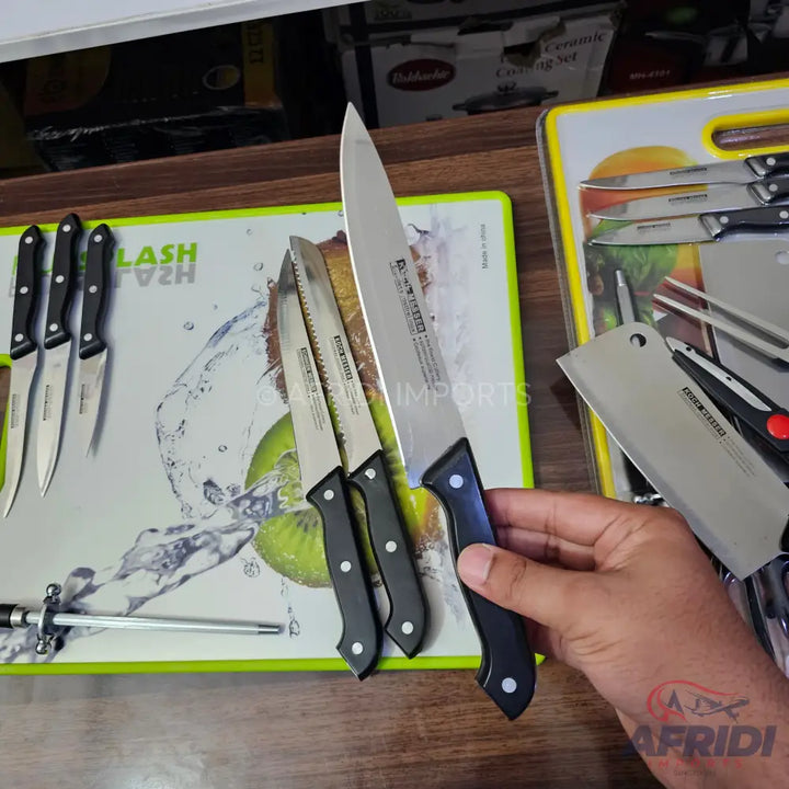 A set of kitchen knives with black handles.