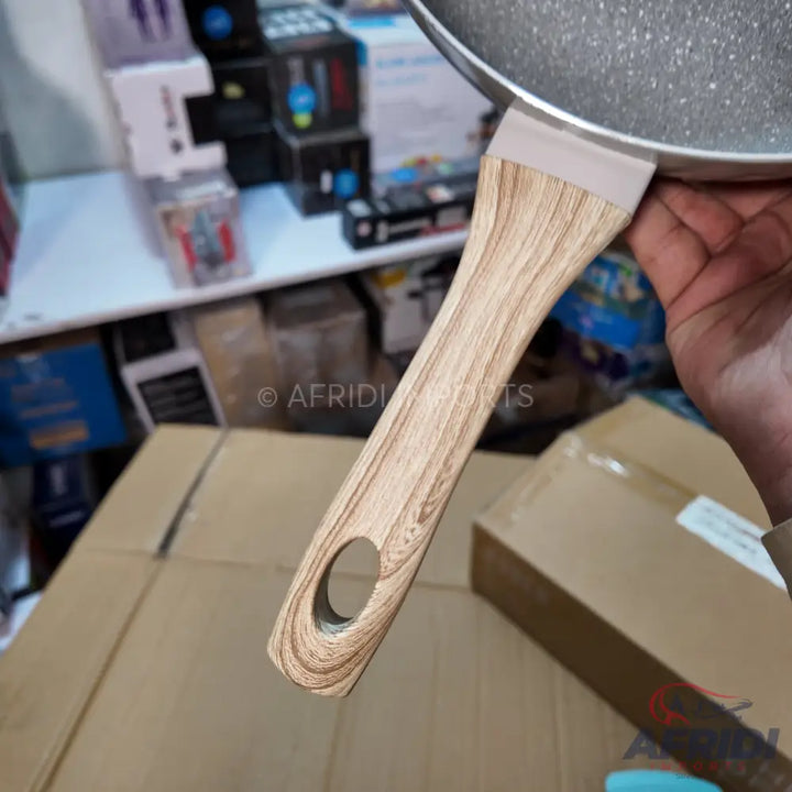 Non-stick frying pan with a light wood-grain handle.