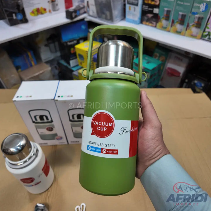 Green stainless steel vacuum cup with a top handle.