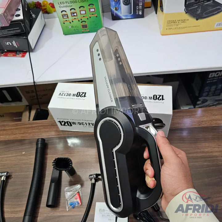 Black and clear handheld car vacuum cleaner with attachments.