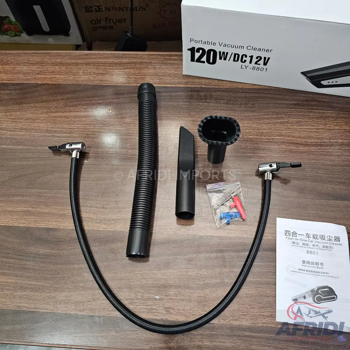 A portable car vacuum cleaner with multiple attachments and a user manual.