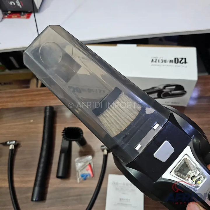 A handheld car vacuum cleaner with multiple attachments and a clear dustbin.