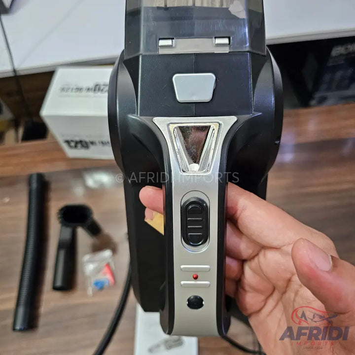Black and silver handheld car vacuum cleaner with multiple attachments.