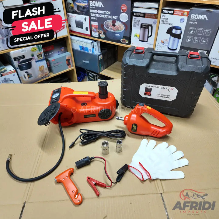 An orange electric car jack and impact wrench set with accessories, stored in a black carrying case.