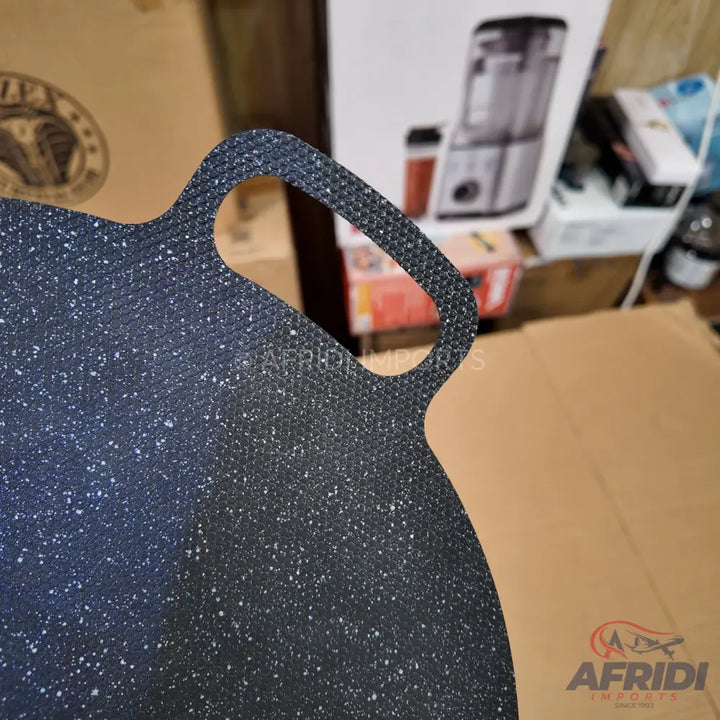 Dark, speckled, non-stick frying pan with an integrated handle.
