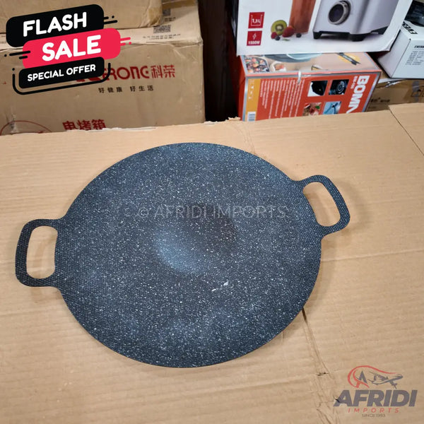Round, dark gray granite-coated flat pan with two integrated handles.