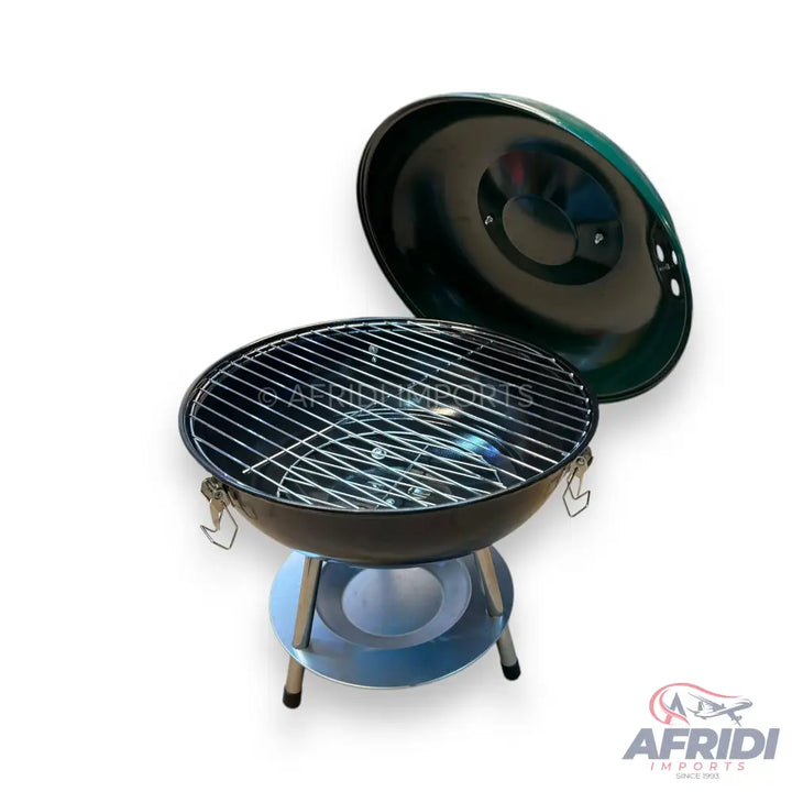 Black portable charcoal grill with a removable lid and two cooking grates.