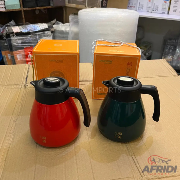 Two insulated carafes, one red and one dark green, with black handles and lids.