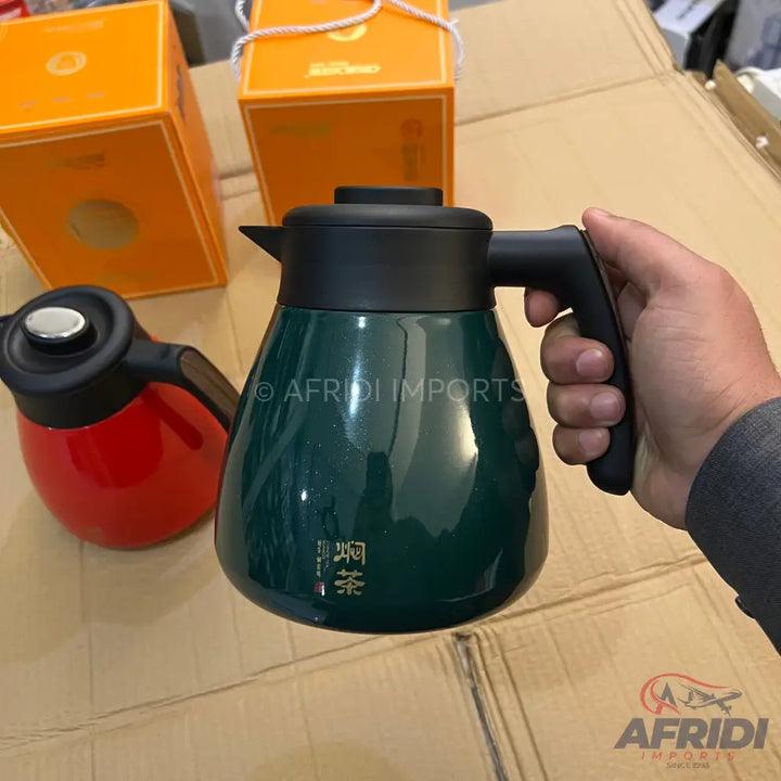Dark green thermal carafe with a black handle and lid.