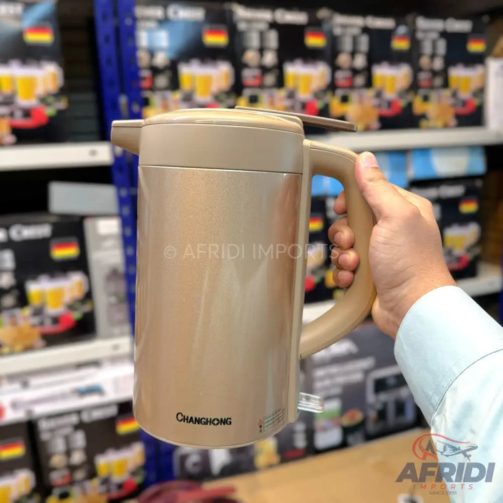 Beige electric kettle with a handle.