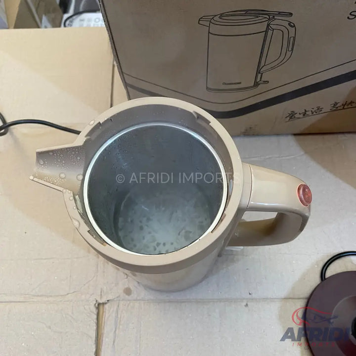 Beige electric kettle with a stainless steel interior and a visible heating element.