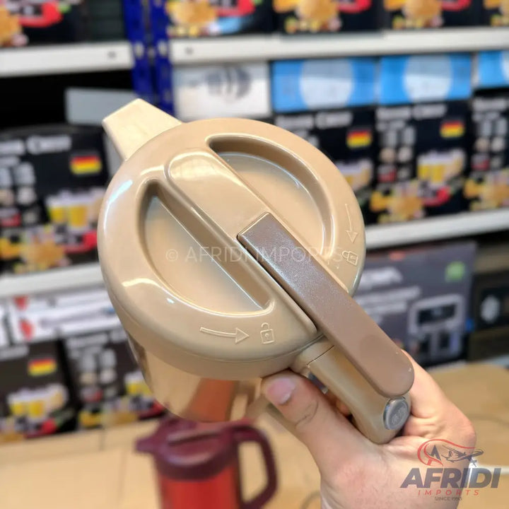 Beige plastic pump-action vacuum flask lid.