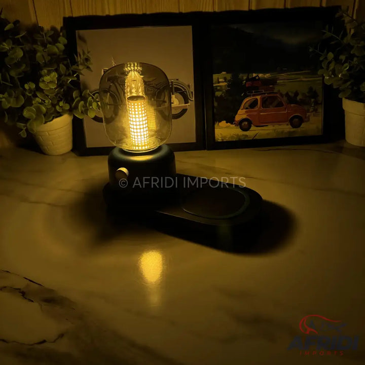 A desk lamp with a clear, uniquely shaped glass bulb and a dark base featuring a small control knob.