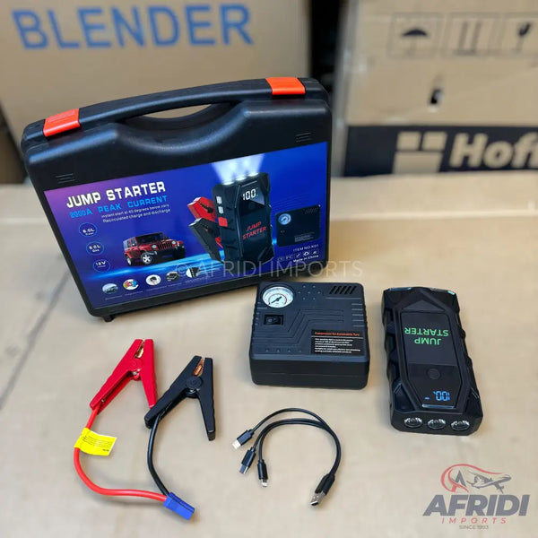 Portable car jump starter kit with an air compressor and charging cables.