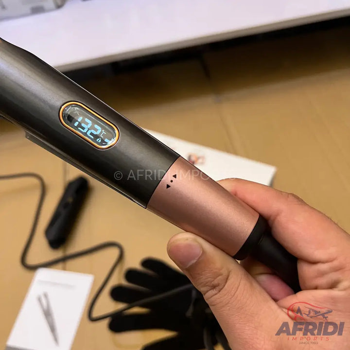 A black and rose gold automatic hair curler with a digital temperature display.